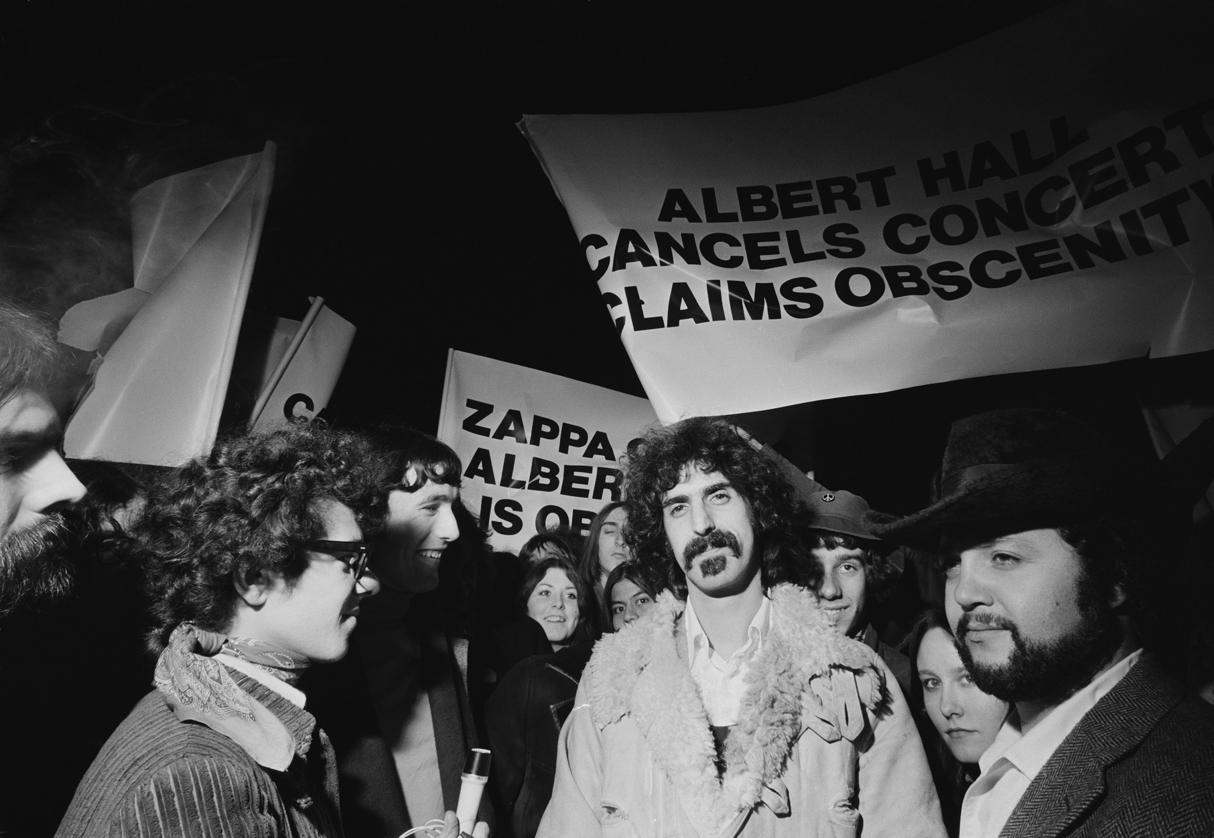 Frank Zappa outside the Royal Albert Hall, where a musical performance of his film <i>200 Motels</i> was cancelled at short notice due to claims of obscenity, London, U.K., February 9, 1971. Perhaps a defining moment for Zappa, who would go on to fight censorship and speak at the U.S. Senate PMRC Hearings in 1985. Photo via Daily Express/Getty Images.